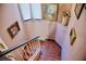 Cozy staircase featuring wood steps, white railings, and artwork displayed along the pink walls at 9113 Anchor Cove Ct, Las Vegas, NV 89117