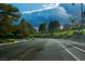 Scenic neighborhood street with lush greenery and a cyclist enjoying the peaceful surroundings at 9113 Anchor Cove Ct, Las Vegas, NV 89117