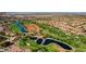 Beautiful aerial view of the community golf course and water features set against a mountain backdrop at 9449 Grand Mesa Dr, Las Vegas, NV 89134