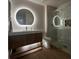 Modern bathroom with lighted mirror, double vanity, and glass-enclosed shower at 9449 Grand Mesa Dr, Las Vegas, NV 89134