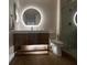Modern bathroom with a sleek vanity, illuminated mirror, and glass-enclosed shower at 9449 Grand Mesa Dr, Las Vegas, NV 89134