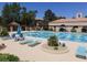 Large community pool with lounge chairs and surrounding landscaping at 9449 Grand Mesa Dr, Las Vegas, NV 89134