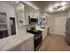 Bright kitchen featuring white cabinets, stainless steel appliances, and quartz countertops at 9449 Grand Mesa Dr, Las Vegas, NV 89134