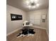 Bright home office with ample natural light, a minimal desk setup, and cow print rug at 9449 Grand Mesa Dr, Las Vegas, NV 89134