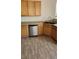 Bright kitchen featuring modern stainless steel dishwasher and natural wood cabinetry at 10524 Congaree St, Las Vegas, NV 89141