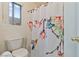 Bright bathroom with decorative floral shower curtain and window at 11007 Vallerosa St, Las Vegas, NV 89141