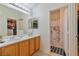 Dual sink bathroom with tile floors and a separate water closet at 11007 Vallerosa St, Las Vegas, NV 89141