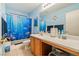 Bright bathroom features a charming ocean-themed shower curtain and blue walls at 11007 Vallerosa St, Las Vegas, NV 89141