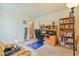 Cozy bedroom with a functional desk, chair, and a well-stocked bookcase at 11007 Vallerosa St, Las Vegas, NV 89141