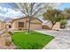Inviting single-story home with a two-car garage, manicured lawn, and desert landscaping at 11007 Vallerosa St, Las Vegas, NV 89141