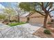 Charming single-story home with a two-car garage, manicured lawn, and xeriscaped front yard at 11007 Vallerosa St, Las Vegas, NV 89141