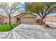 Charming single-story home featuring a two-car garage, xeriscaped yard, and mature shade trees enhancing its curb appeal at 11007 Vallerosa St, Las Vegas, NV 89141