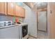 Functional laundry room with modern appliances and built-in storage cabinets at 11007 Vallerosa St, Las Vegas, NV 89141