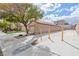 Rear view of a home featuring a long drive way along the side of the house, and low maintenance landscaping at 11007 Vallerosa St, Las Vegas, NV 89141
