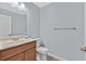 A clean bathroom features a granite countertop, wooden cabinets, and contemporary fixtures at 1112 Bower Basin St, Las Vegas, NV 89144