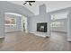 Open-concept living space with a decorative fireplace and large windows for natural light at 1112 Bower Basin St, Las Vegas, NV 89144
