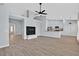 Open floorplan featuring fireplace, stylish ceiling fan, and views into the modern kitchen at 1112 Bower Basin St, Las Vegas, NV 89144