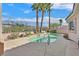 A luxurious swimming pool is surrounded by tall palms and elegant decking, perfect for relaxing at 1112 Bower Basin St, Las Vegas, NV 89144