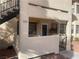 Inviting condo entrance with stairs, security door, and neutral stucco finish at unit 102 at 1112 Observation Dr # 102, Las Vegas, NV 89128