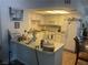 Functional kitchen with white cabinets, a breakfast bar, and essential appliances at 1112 Observation Dr # 102, Las Vegas, NV 89128