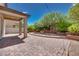 Wide-open backyard patio featuring a brick-paved area, manicured landscaping, and a covered patio at 1427 Brushback Ave, Henderson, NV 89074