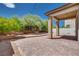 Backyard with a brick-paved patio, a covered area, and a landscaped fire pit feature at 1427 Brushback Ave, Henderson, NV 89074