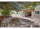 Spacious backyard patio with paved stones, a central fire pit, and landscaped planters at 1427 Brushback Ave, Henderson, NV 89074