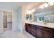 Ensuite bath features double sink vanity, and walk-in closet with built-in shelving at 1427 Brushback Ave, Henderson, NV 89074
