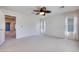 Spacious bedroom features carpet flooring, ceiling fan, and is adjacent to the ensuite bath at 1427 Brushback Ave, Henderson, NV 89074