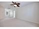 Large bedroom with a ceiling fan, neutral carpet, and access to other rooms at 1427 Brushback Ave, Henderson, NV 89074