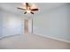 Bedroom with neutral carpet, a ceiling fan, and closet space for storage at 1427 Brushback Ave, Henderson, NV 89074