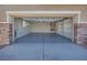 Spacious garage with ample lighting, built-in shelving, and neutral-colored walls at 1427 Brushback Ave, Henderson, NV 89074