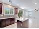 Open concept kitchen featuring granite counters, island, stainless steel appliances and eat-in area at 1427 Brushback Ave, Henderson, NV 89074