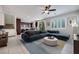 Open-concept living room featuring tile floors, modern furniture, and large windows with views of the backyard at 1427 Brushback Ave, Henderson, NV 89074