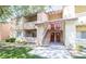 Two-story building with balcony access, red doors and landscaped lawn for an inviting curb appeal at 1455 E Katie Ave # 16, Las Vegas, NV 89119