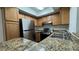 Well-lit kitchen featuring stainless steel appliances and granite countertops at 1455 E Katie Ave # 16, Las Vegas, NV 89119