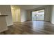 Living room featuring sliding glass door access to balcony, and wood look flooring at 1455 E Katie Ave # 16, Las Vegas, NV 89119