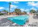 Community pool with covered seating, palm trees, and sunny skies at 1455 E Katie Ave # 16, Las Vegas, NV 89119