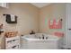 Bathroom features a corner soaking tub with bronze hardware and decorative towels at 1546 Georgia Ave, Boulder City, NV 89005
