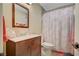 Bathroom featuring a shower with patterned curtain, vanity, mirror, and toilet at 1546 Georgia Ave, Boulder City, NV 89005