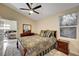 Cozy bedroom with decorative bedding, dark wood furniture, and a view of the backyard at 1546 Georgia Ave, Boulder City, NV 89005