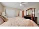 Bedroom with beige walls, a ceiling fan, and comfortable furnishings at 1546 Georgia Ave, Boulder City, NV 89005