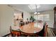 Elegant dining room features a large wooden table, ornate rug, and bright natural light at 1546 Georgia Ave, Boulder City, NV 89005