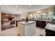 Open-concept kitchen with granite countertops, a center island, and a view of the living room at 1546 Georgia Ave, Boulder City, NV 89005