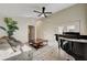 Bright living room with modern ceiling fan, piano, and comfortable seating area with accent pillows at 1546 Georgia Ave, Boulder City, NV 89005