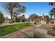 Large backyard with green grass, mature trees and several patio areas at 1801 S 15Th St, Las Vegas, NV 89104
