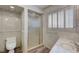 Well-lit bathroom featuring a toilet, glass shower, and window shutters at 1801 S 15Th St, Las Vegas, NV 89104