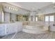 Bright bathroom with a corner bathtub, marble vanity and sink with large mirrors at 1801 S 15Th St, Las Vegas, NV 89104