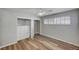 Neutral bedroom with a built in closet system, wood-look floors and white ceiling fan at 1801 S 15Th St, Las Vegas, NV 89104