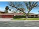 Charming single-story home with a well-manicured lawn and mature landscaping and a red tone at 1801 S 15Th St, Las Vegas, NV 89104
